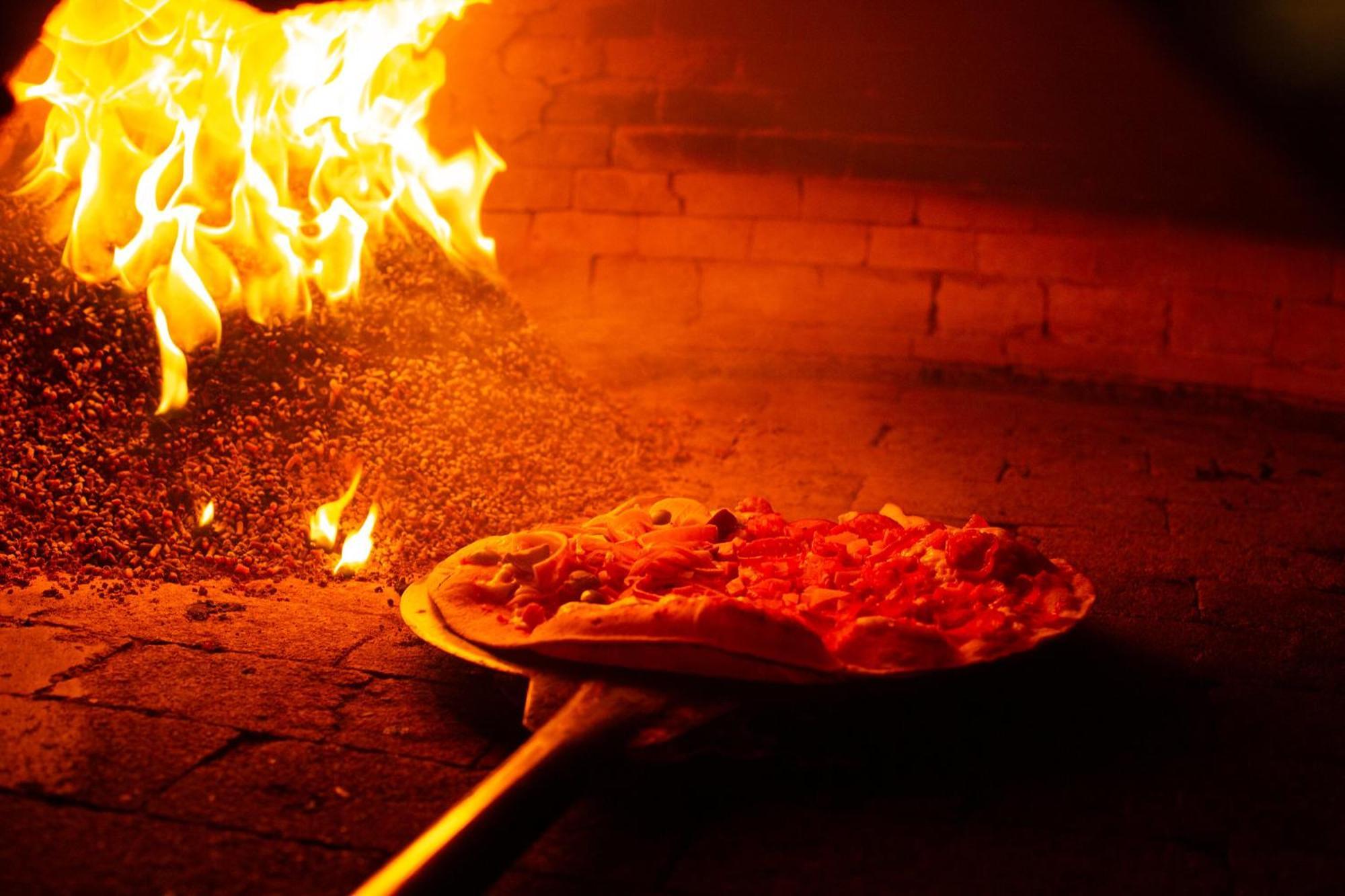 Costao Do Santinho Resort All Inclusive Florianopolis Exterior photo Pizza being cooked in a wood-fired oven